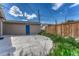 Backyard featuring a concrete patio surrounded by a wooden fence and grassy foliage at 7301 Dale Ct, Westminster, CO 80030