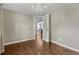 Spacious bedroom with hardwood floors and natural light, leading to dining area at 7301 Dale Ct, Westminster, CO 80030