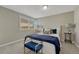 Well-lit bedroom featuring a cozy queen bed, side tables, and a large window at 7301 Dale Ct, Westminster, CO 80030