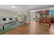Open living room with hardwood floors, seamlessly connected to the modern kitchen at 7301 Dale Ct, Westminster, CO 80030