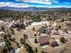 Panoramic aerial view showcases the home nestled among trees with mountain views in the distance at 20217 Kenneth Lainer Dr, Monument, CO 80132