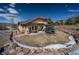 Beautifully landscaped backyard with a stone-lined stream and a cozy patio seating area at 20217 Kenneth Lainer Dr, Monument, CO 80132