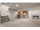 Finished basement with a bar area, wood barstools, stairs and neutral colors at 20217 Kenneth Lainer Dr, Monument, CO 80132