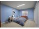 A bright blue bedroom with natural light, carpet, and modern furnishings at 20217 Kenneth Lainer Dr, Monument, CO 80132