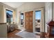 Light-filled foyer with hardwood floors and a solid wood front door at 20217 Kenneth Lainer Dr, Monument, CO 80132