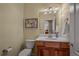 Stylish half bathroom features wood vanity, marble sink, and decorative wall art at 20217 Kenneth Lainer Dr, Monument, CO 80132