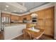 Kitchen featuring wooden cabinetry, granite countertops, stainless appliances, and an eat-in dining table at 20217 Kenneth Lainer Dr, Monument, CO 80132