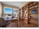 Bright office boasts custom built-in bookshelves, hardwood floors, and a large window with views at 20217 Kenneth Lainer Dr, Monument, CO 80132