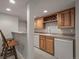 The basement has a modern wet bar with wood cabinets, a wine rack, and a small refrigerator at 20217 Kenneth Lainer Dr, Monument, CO 80132