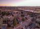 A captivating neighborhood view with the home distinguished by a red arrow, set against a backdrop of sunset-kissed mountains at 6721 S Clayton Way, Centennial, CO 80122