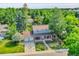 Aerial view of lovely home surrounded by lush greenery and a well-manicured lawn at 6721 S Clayton Way, Centennial, CO 80122