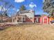 Two-story home's backyard features a large patio, shed, and expansive grassy area at 6721 S Clayton Way, Centennial, CO 80122