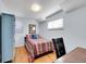 Bright bedroom featuring a twin bed, hardwood floors, and two windows offering natural light, complemented by a desk space at 6721 S Clayton Way, Centennial, CO 80122