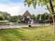 Outdoor swimming pool with lounge chairs and a unique A-frame pool house at 6721 S Clayton Way, Centennial, CO 80122