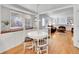 Bright dining area with white table and chairs, with view to living room and fireplace at 6721 S Clayton Way, Centennial, CO 80122