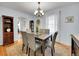 Charming dining room featuring a wooden table, upholstered chairs, and a stylish chandelier with an ornate display cabinet at 6721 S Clayton Way, Centennial, CO 80122