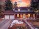 Attractive two-story home featuring a front porch, a two-car garage and beautiful sunset views at 6721 S Clayton Way, Centennial, CO 80122