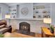 Close-up of a brick fireplace with a decorative mantel and built-in shelving at 6721 S Clayton Way, Centennial, CO 80122