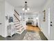 Foyer with staircase and view into the living room showcasing the open floor plan at 6721 S Clayton Way, Centennial, CO 80122