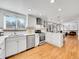 Bright kitchen with white cabinets, stainless steel appliances, and hardwood floors at 6721 S Clayton Way, Centennial, CO 80122