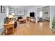 Open living room featuring a brick fireplace, built-in shelves, and hardwood floors at 6721 S Clayton Way, Centennial, CO 80122