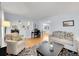 Bright living room with a decorative rug, neutral furniture, and light blue walls at 6721 S Clayton Way, Centennial, CO 80122