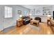 Cozy living room with a brick fireplace, built-in shelving, and hardwood floors at 6721 S Clayton Way, Centennial, CO 80122