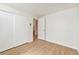 Basement bedroom with mirrored closet doors and wood floor at 3912 S Atchison Way # E, Aurora, CO 80014