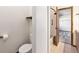 Clean bathroom with tub, toilet and small shelf at 3912 S Atchison Way # E, Aurora, CO 80014