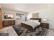 Virtually staged main bedroom with wood furniture at 3912 S Atchison Way # E, Aurora, CO 80014