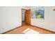 Bright bedroom with hardwood floors and access to hallway at 3912 S Atchison Way # E, Aurora, CO 80014