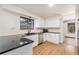 Modern kitchen with white cabinets and black countertops at 3912 S Atchison Way # E, Aurora, CO 80014