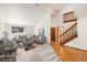 Virtually staged living room with vaulted ceilings and hardwood floors at 3912 S Atchison Way # E, Aurora, CO 80014