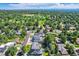 Wide aerial view of the neighborhood, displaying lush greenery and golf course at 3695 E Dartmouth Ave, Denver, CO 80210