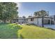 Expansive backyard featuring lush lawn, a basketball hoop, and a patio area perfect for entertaining at 3695 E Dartmouth Ave, Denver, CO 80210