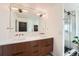 Sleek bathroom featuring double sinks, modern fixtures, and a glass-enclosed shower at 3695 E Dartmouth Ave, Denver, CO 80210