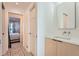 Modern bathroom with stylish vanity and patterned floor, adjoining bedroom at 3695 E Dartmouth Ave, Denver, CO 80210