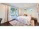 Sunlit bedroom with large windows, plush rug, and a comfortable bed, creating a cozy retreat at 3695 E Dartmouth Ave, Denver, CO 80210