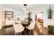Elegant dining room with a large table, stylish lighting, and an open layout at 3695 E Dartmouth Ave, Denver, CO 80210