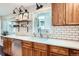 Bright kitchen with white subway tile, wood cabinets, floating shelves and stainless steel appliances at 3695 E Dartmouth Ave, Denver, CO 80210