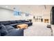 Spacious living room in the basement with a large sofa, a coffee table, and game room at 3695 E Dartmouth Ave, Denver, CO 80210