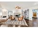 Inviting living room with white painted brick fireplace, ceiling fan, and two leather armchairs at 3695 E Dartmouth Ave, Denver, CO 80210
