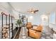 Cozy living room with textured fireplace, ceiling fan, leather chairs, and hardwood floors at 3695 E Dartmouth Ave, Denver, CO 80210