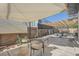 Covered patio area with wicker furniture and decorative privacy screens, perfect for outdoor relaxation at 3695 E Dartmouth Ave, Denver, CO 80210