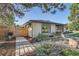 Well-maintained side yard with tasteful landscaping, modern walkway, and a privacy fence at 3695 E Dartmouth Ave, Denver, CO 80210
