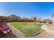 Spacious backyard with a lush lawn, wooden fence, and an elevated deck for entertaining at 4073 S Liverpool St, Aurora, CO 80013