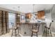 A finished basement wet bar featuring custom wood cabinetry and attractive pendant lighting at 4073 S Liverpool St, Aurora, CO 80013