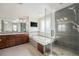 Luxurious bathroom with a walk-in shower, jetted tub, and a modern vanity at 4073 S Liverpool St, Aurora, CO 80013