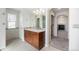Bathroom with a stylish wood vanity, modern fixtures, and a view of an adjacent room at 4073 S Liverpool St, Aurora, CO 80013