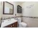 Charming bathroom featuring tile accents, decorative wall art, and a classic vanity at 4073 S Liverpool St, Aurora, CO 80013